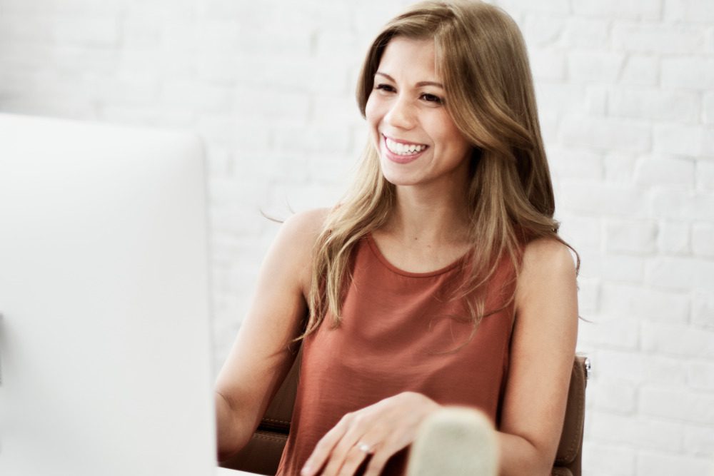 Cheerful woman at her computer.