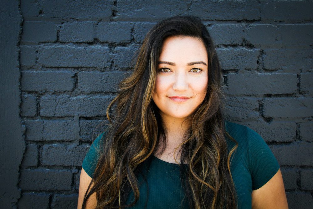 woman against brick wall